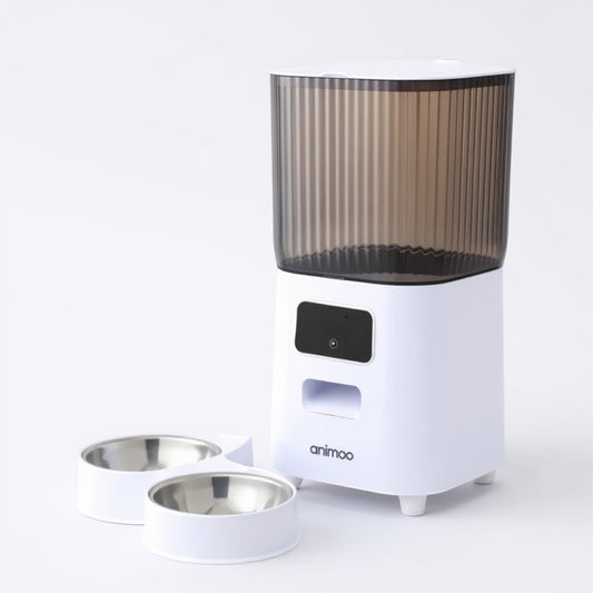 Animoo automatic pet feeder with camera, microphone, and dual stainless steel bowls. White with a smoked plastic hopper.