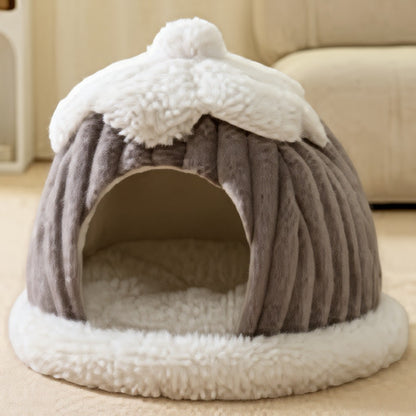 Animoo grey plush pet bed shaped like a dome with a fluffy white trim and pompom top. Cozy and warm.