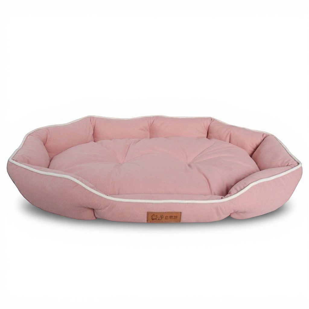 Animoo pink suede-effect dog bed with raised edges and white piping, offering ultimate comfort and a secure cocoon.