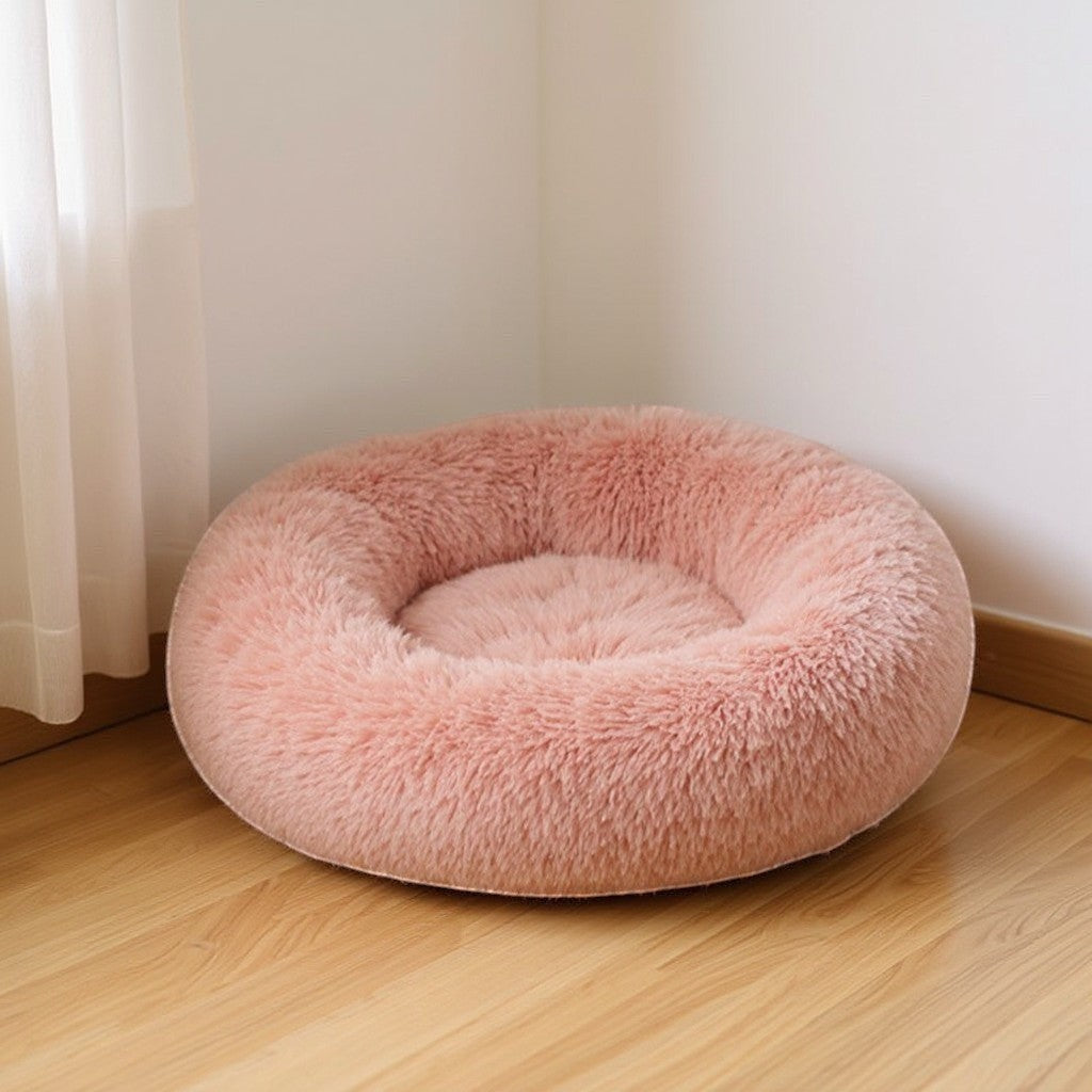 Animoo plush round dog bed in soft pink velvet, washable and comfortable for ultimate pet relaxation.